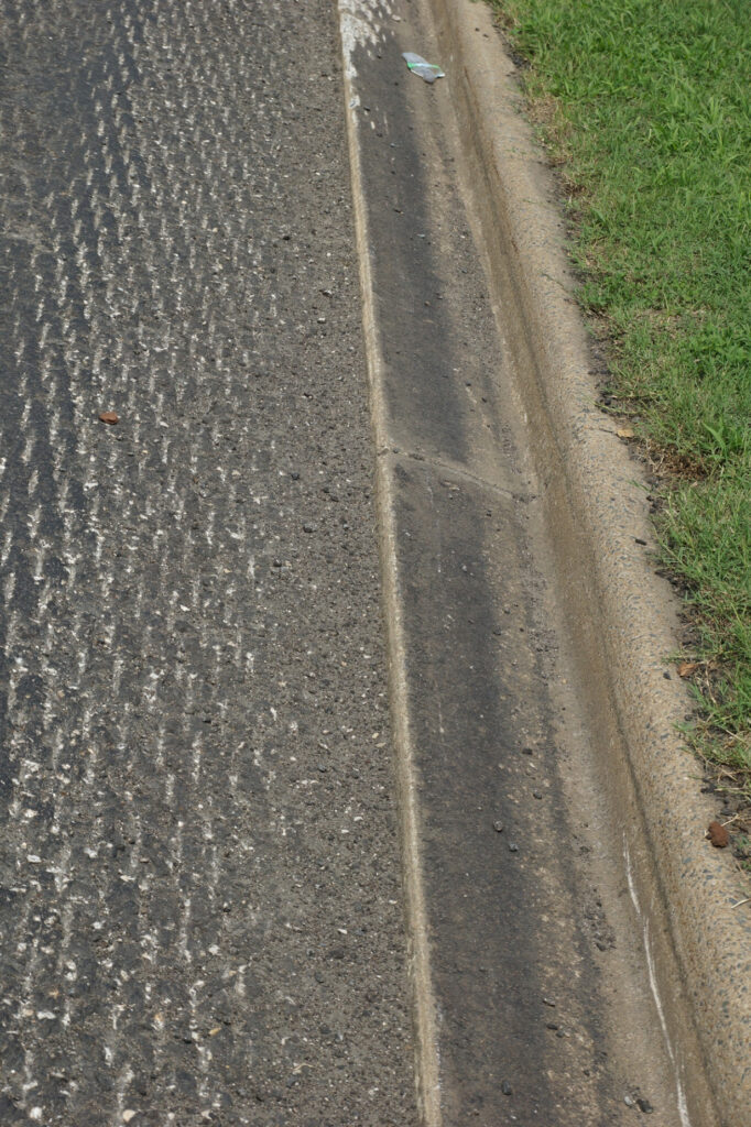 Existing pavement milled two inches below gutter.